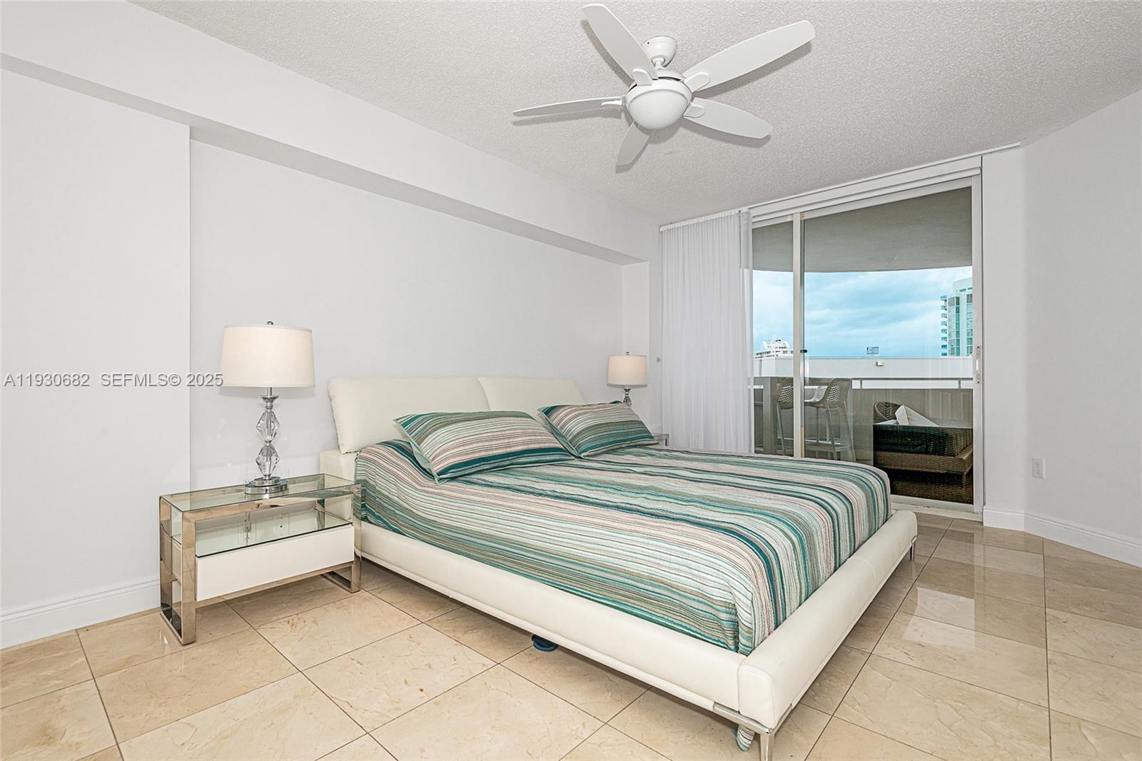 6301 Collins Avenue, Unit 1605 Miami Beach, FL 33141 - Photo 18 of 23 a bedroom with a bed and a table