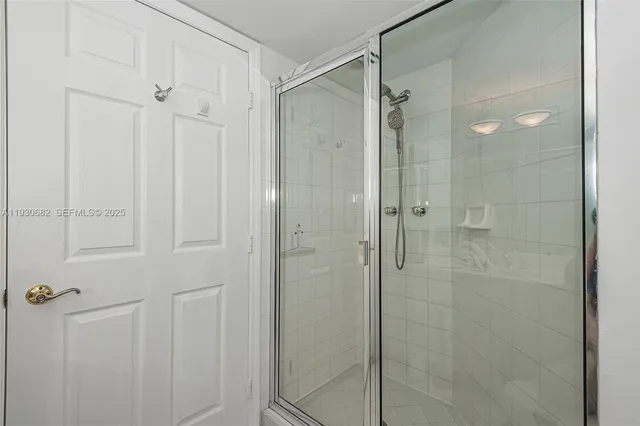 a bathroom with a glass shower door