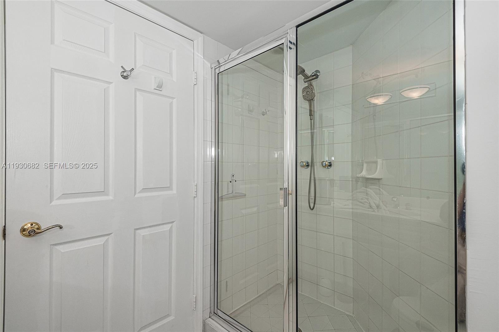 6301 Collins Avenue, Unit 1605 Miami Beach, FL 33141 - Photo 23 of 23 a bathroom with a glass shower door