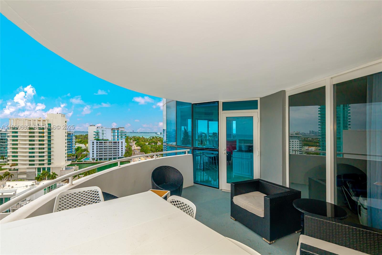 6301 Collins Avenue, Unit 1605 Miami Beach, FL 33141 - Photo 4 of 23 a living room with furniture a floor to ceiling window and floor to ceiling window