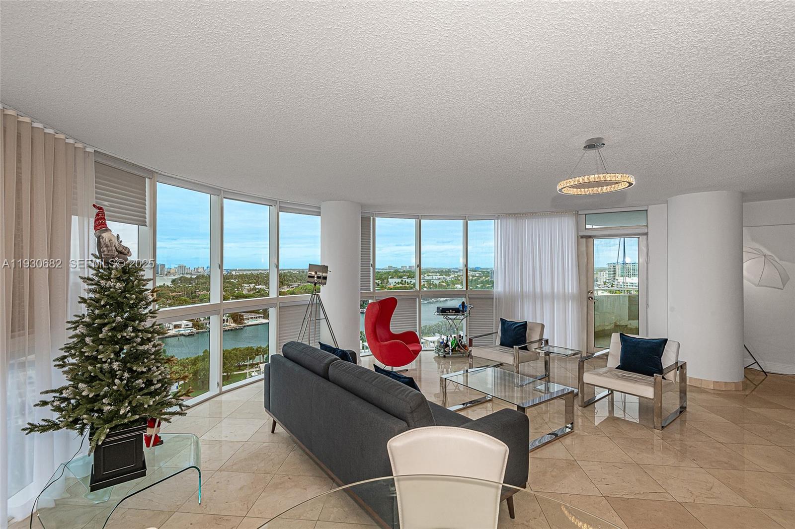 6301 Collins Avenue, Unit 1605 Miami Beach, FL 33141 - Photo 6 of 23 a living room with furniture and a potted plant