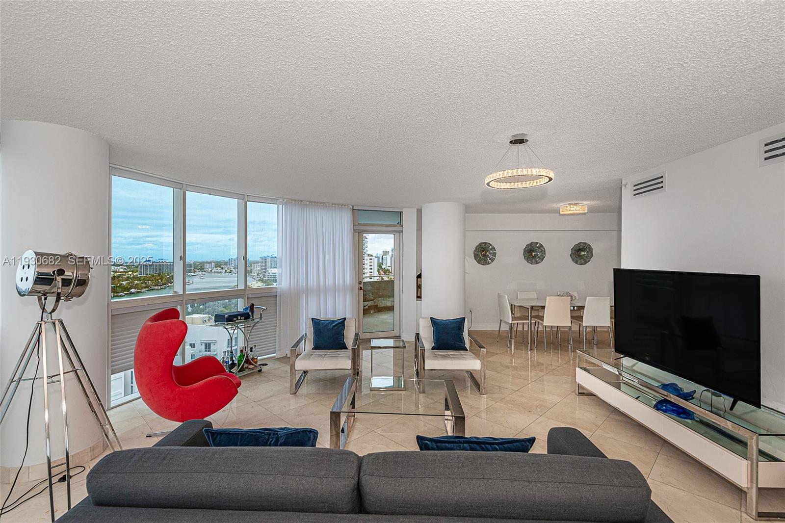 6301 Collins Avenue, Unit 1605 Miami Beach, FL 33141 - Photo 7 of 23 a living room with furniture and a flat screen tv