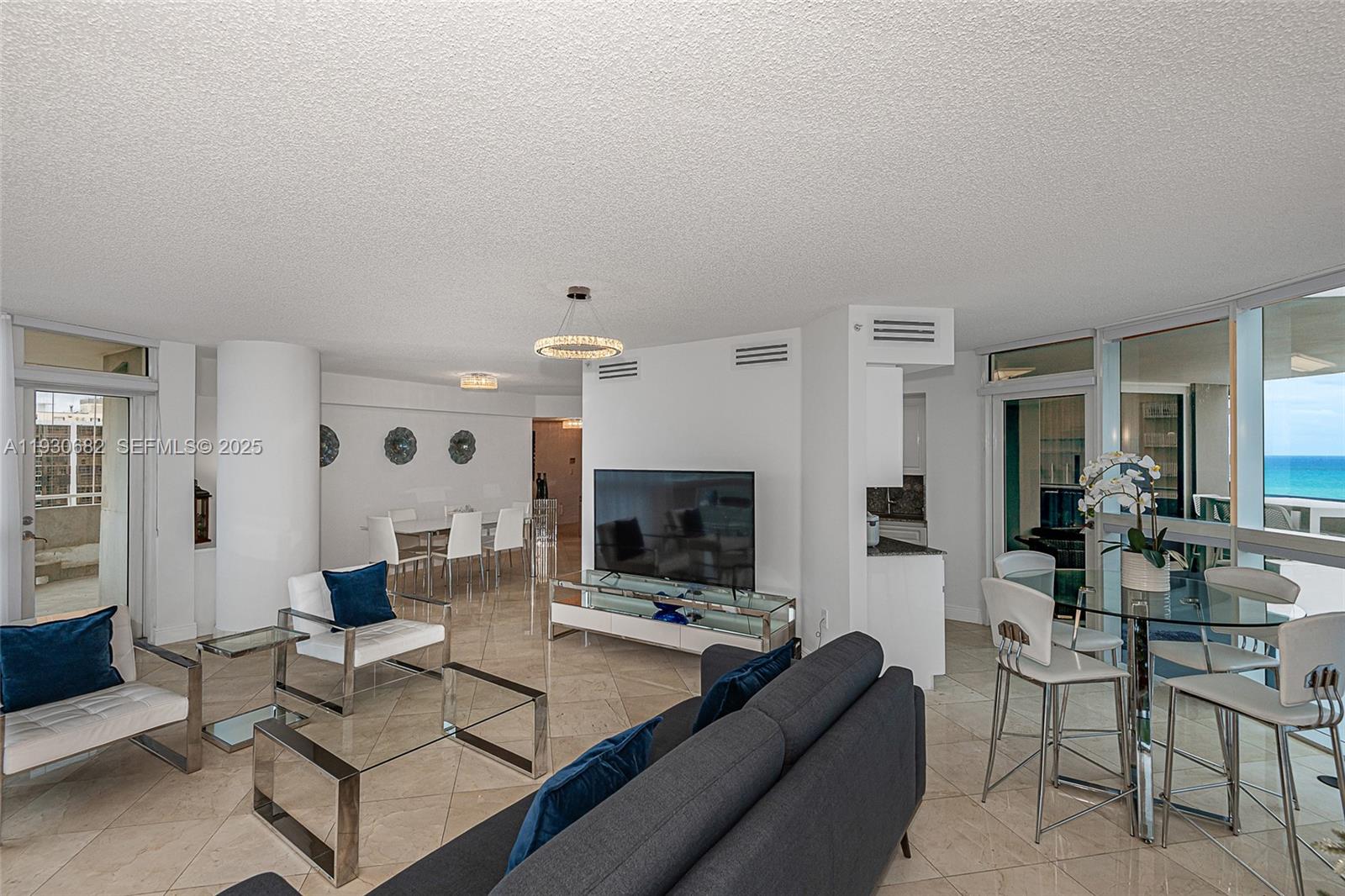 6301 Collins Avenue, Unit 1605 Miami Beach, FL 33141 - Photo 8 of 23 a living room with furniture and a fireplace