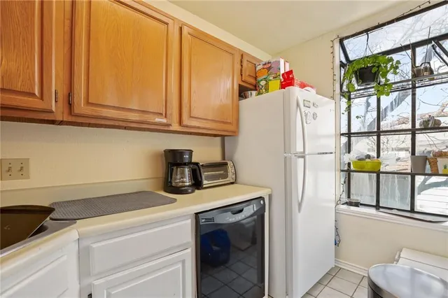 a white refrigerator freezer sitting in a kitchen