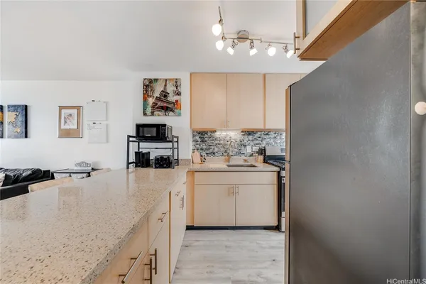 a kitchen with a refrigerator and cabinets