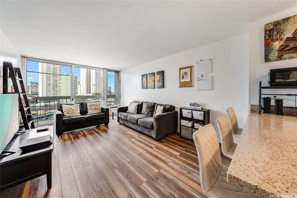 a living room with furniture wooden floor and a flat screen tv