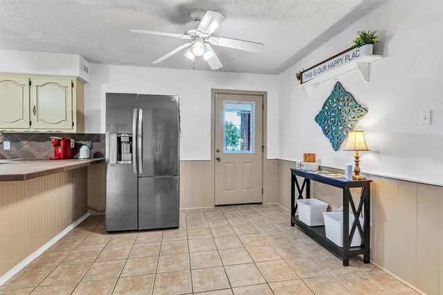 a kitchen with a refrigerator a sink and cabinets