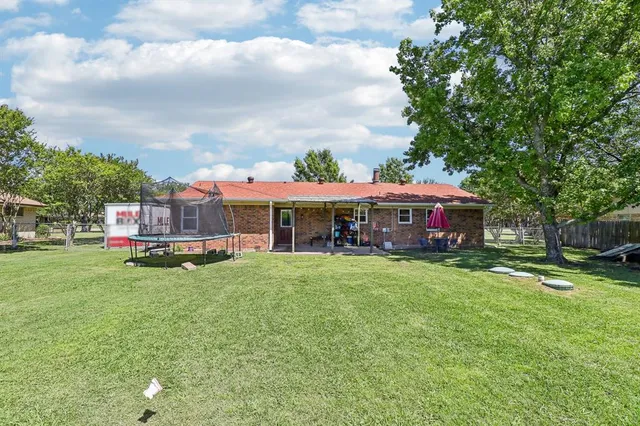 a front view of house with yard and trees