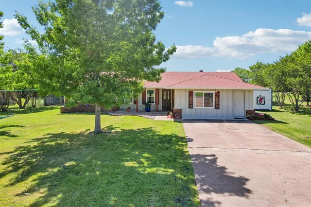 a house with swimming pool in front of it