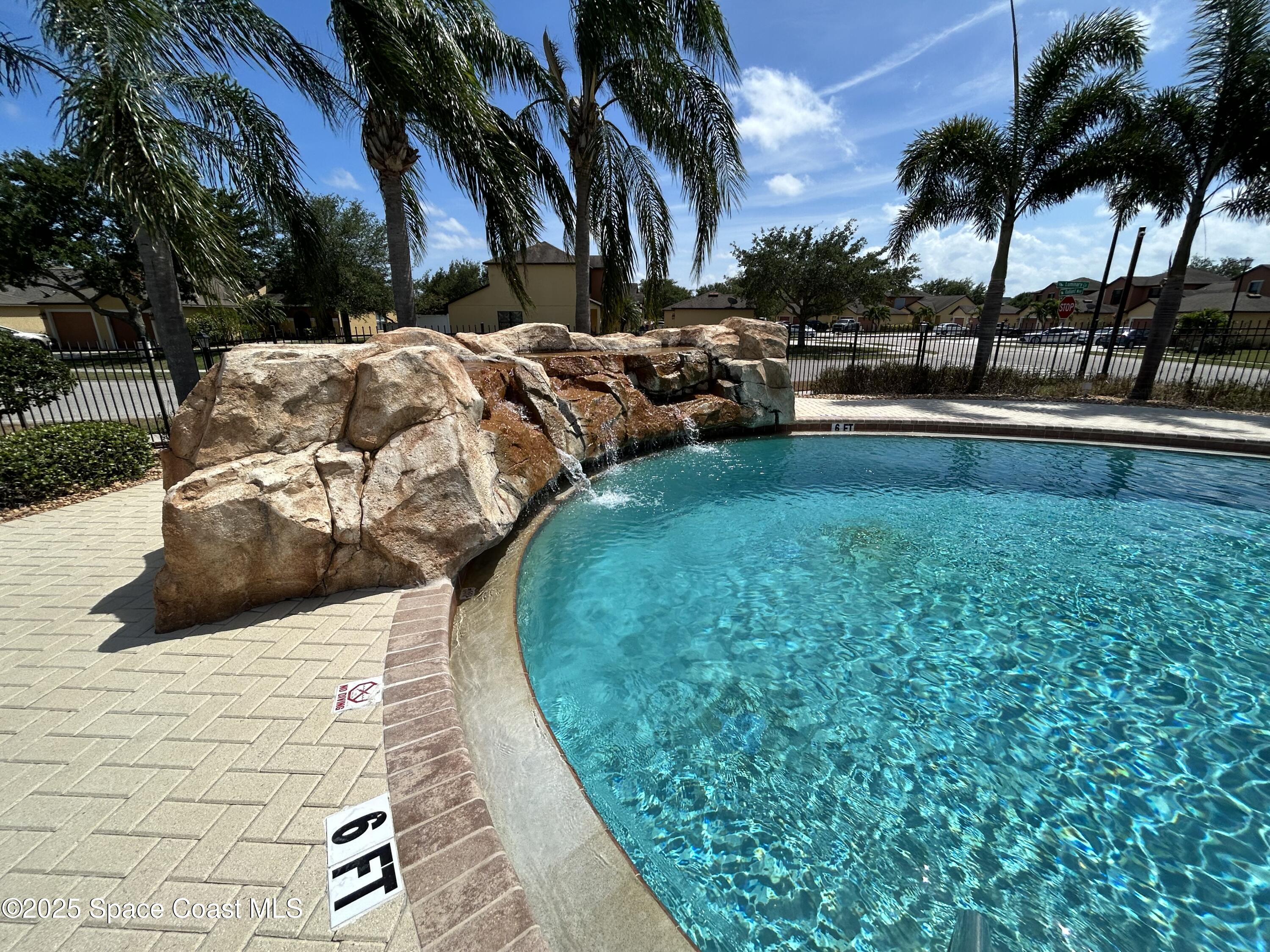 1160 Luminary Circle, Unit 105 Melbourne, FL 32901 - Photo 15 of 16 a view of swimming pool with a table and chairs