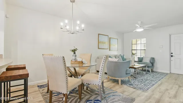 a view of a dining room with furniture and chandelier