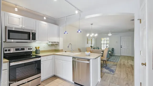 a kitchen with a sink stove and microwave