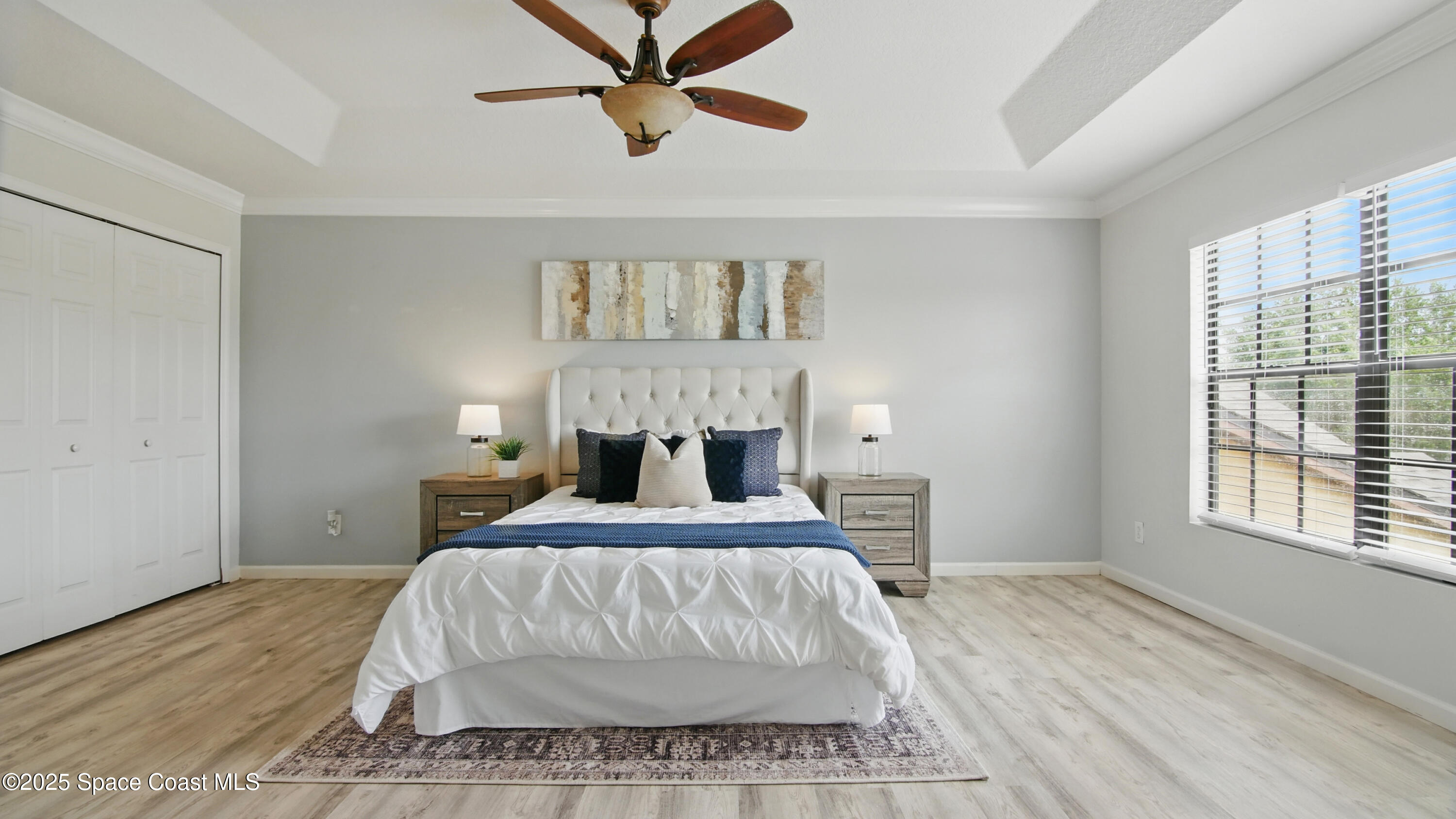 1160 Luminary Circle, Unit 105 Melbourne, FL 32901 - Photo 8 of 16 a bedroom with a large bed and a window