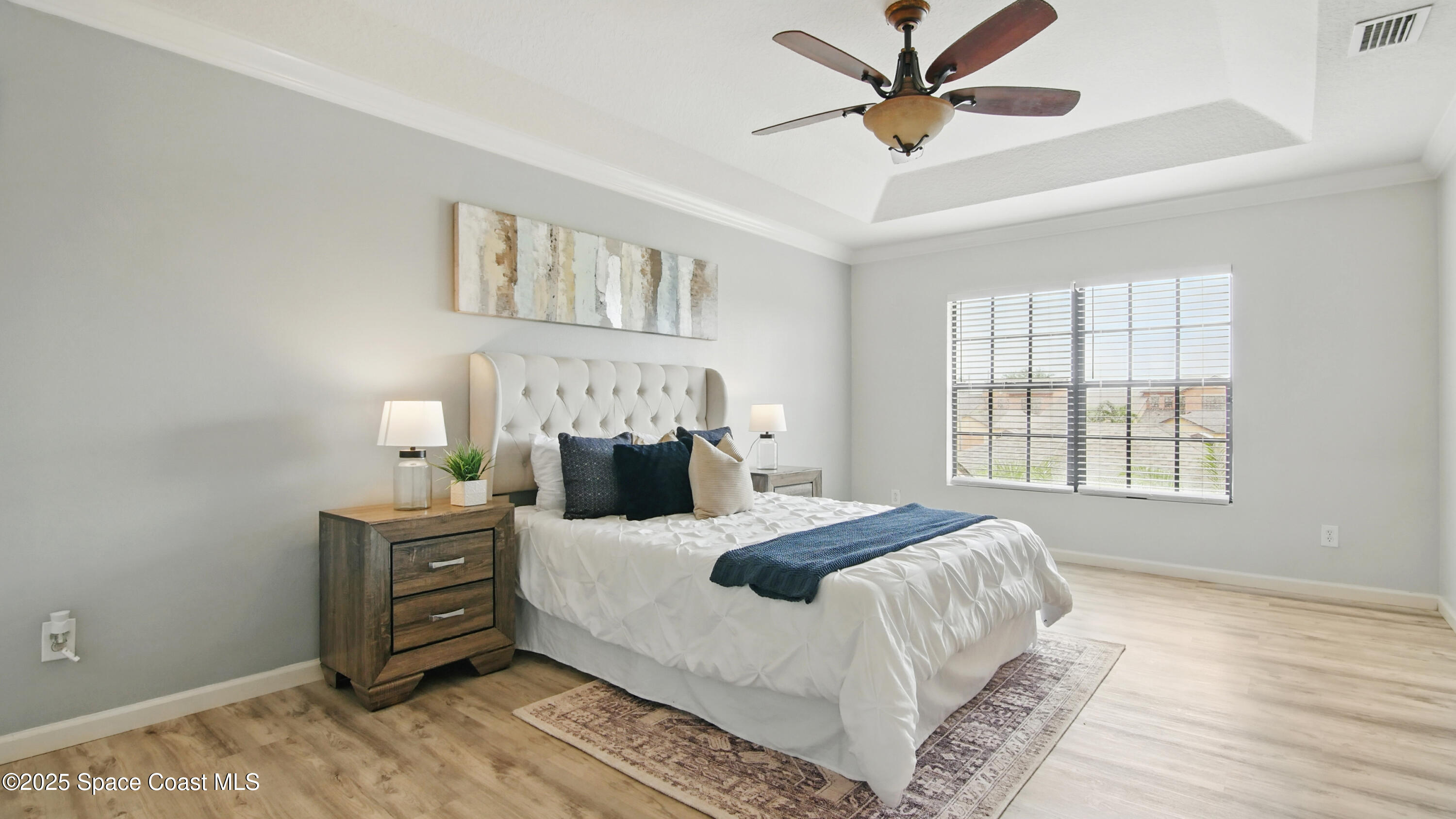 1160 Luminary Circle, Unit 105 Melbourne, FL 32901 - Photo 10 of 16 a bedroom with a bed and a window