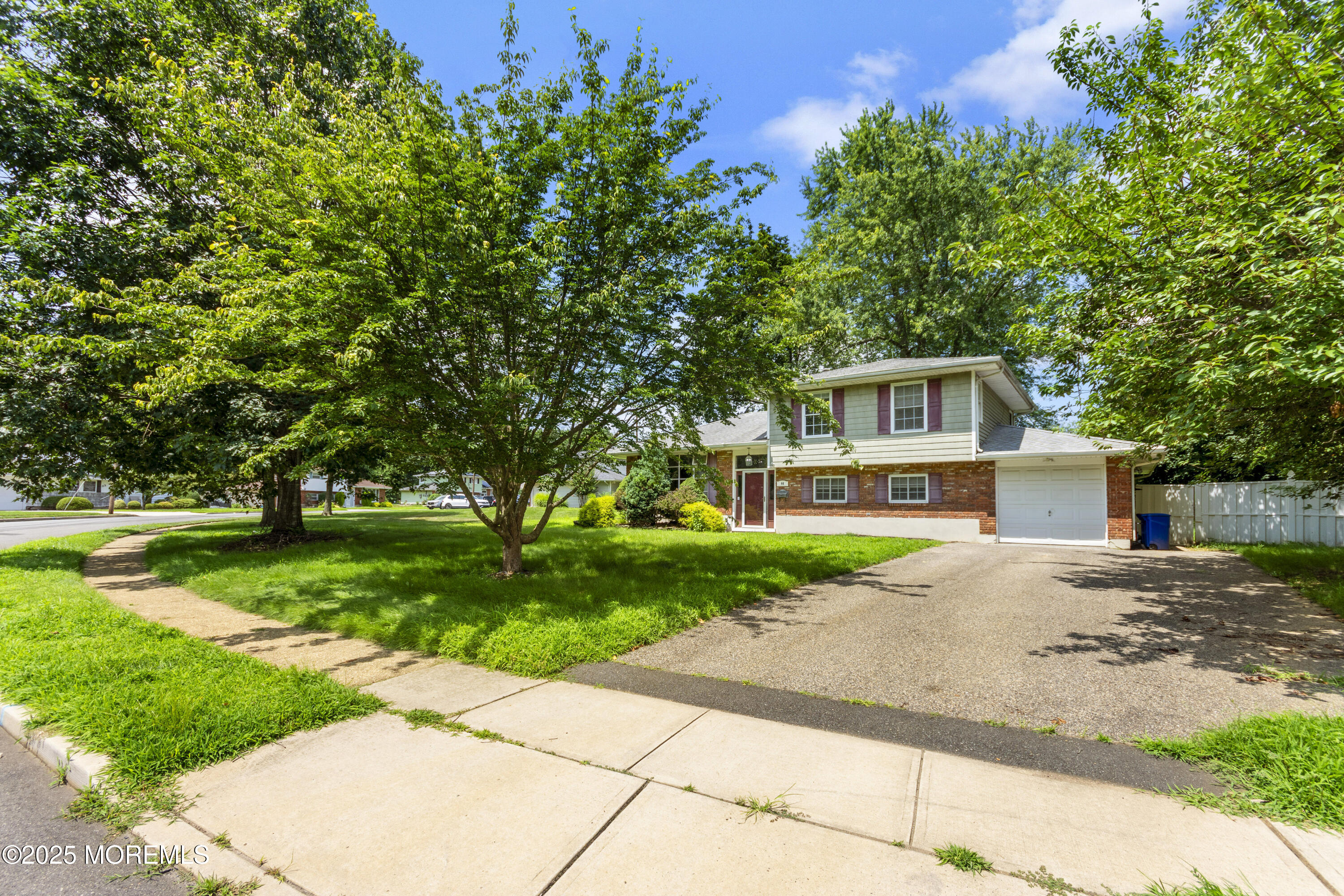 44 Koenig Lane Freehold, NJ 07728 - Photo 4 of 22 a front view of a house with a yard and trees
