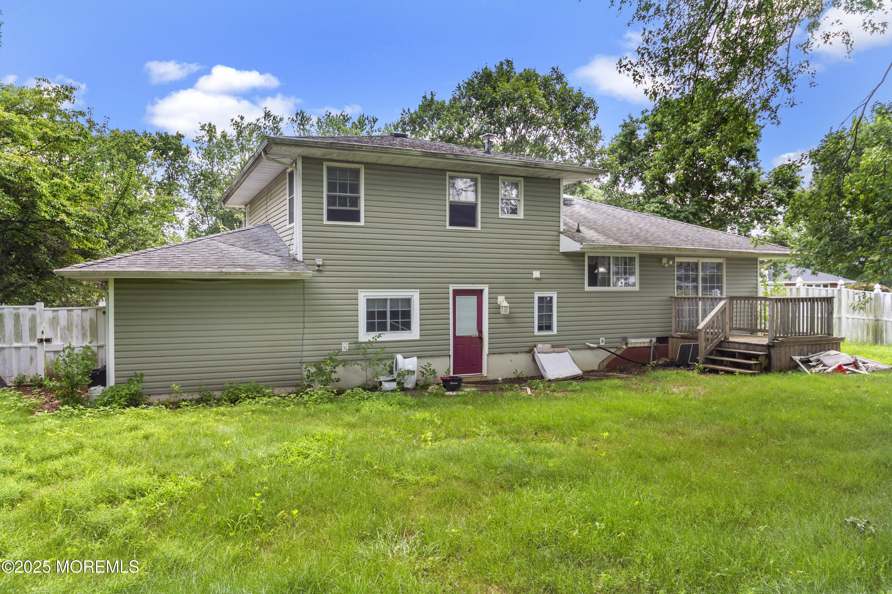 44 Koenig Lane Freehold, NJ 07728 - Photo 5 of 22 a front view of house with yard and trees in the background