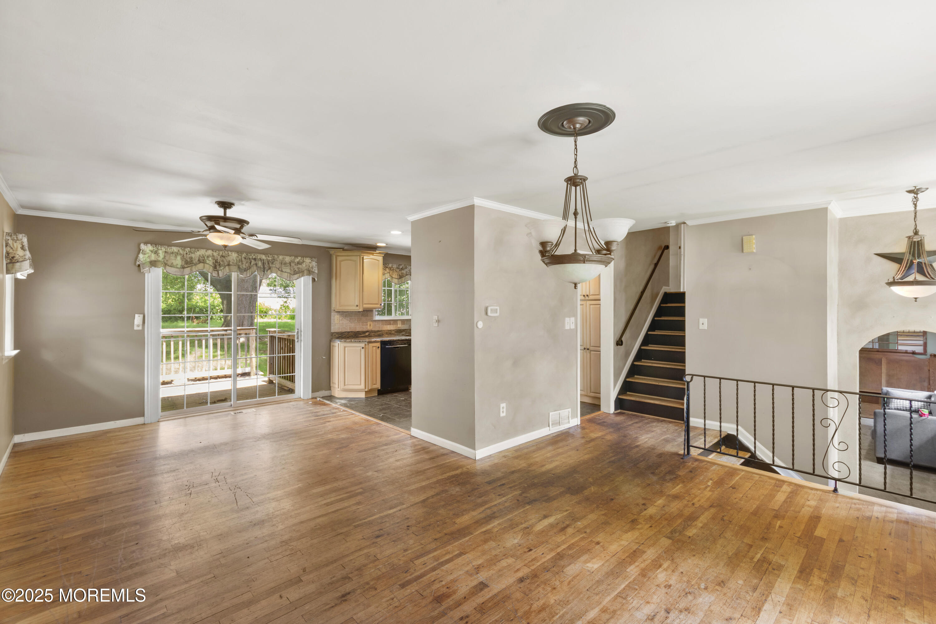44 Koenig Lane Freehold, NJ 07728 - Photo 8 of 22 a view of a livingroom with wooden floor and a ceiling fan