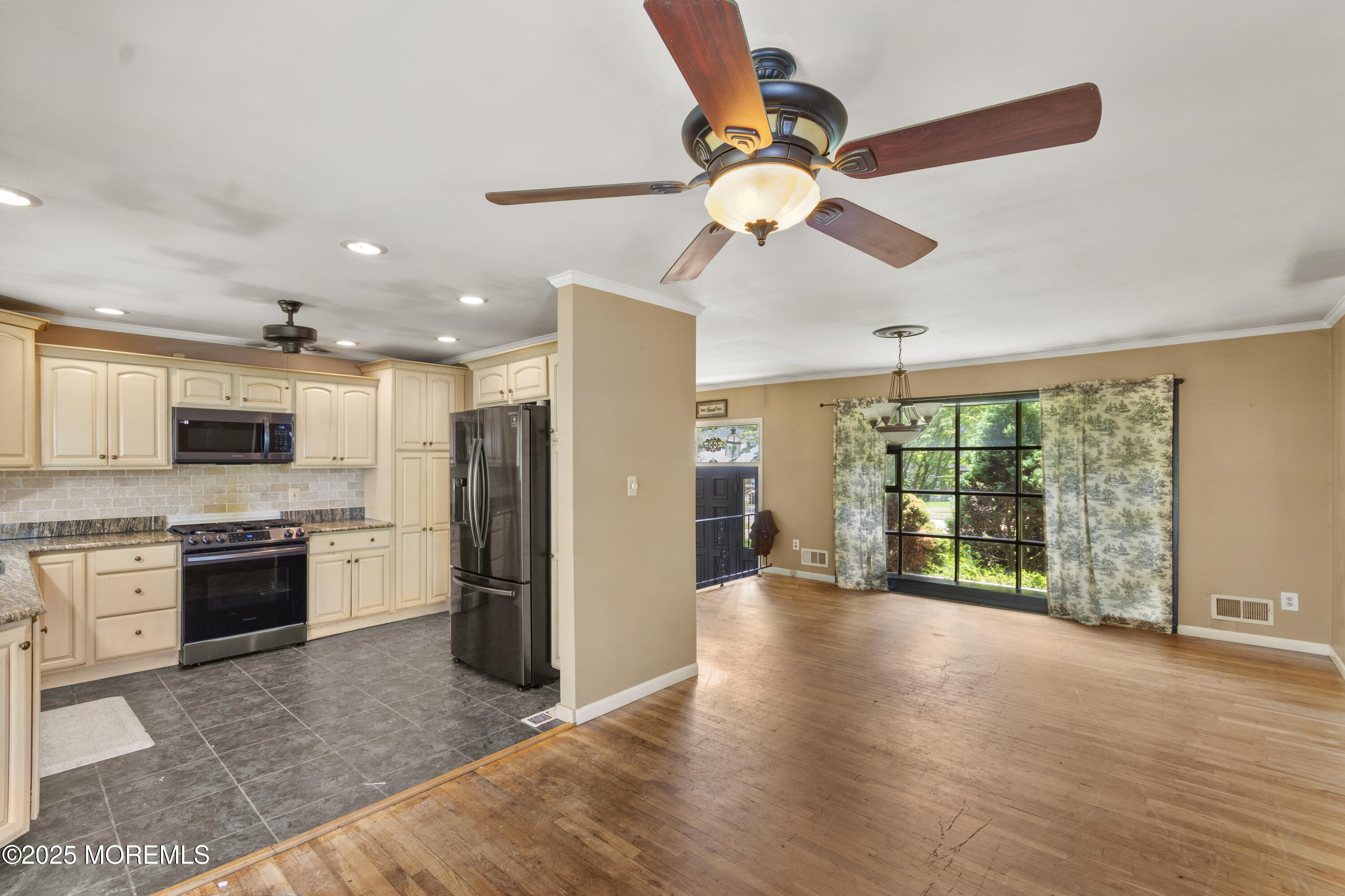 44 Koenig Lane Freehold, NJ 07728 - Photo 9 of 22 a view of a kitchen with a stove cabinets and a ceiling fan