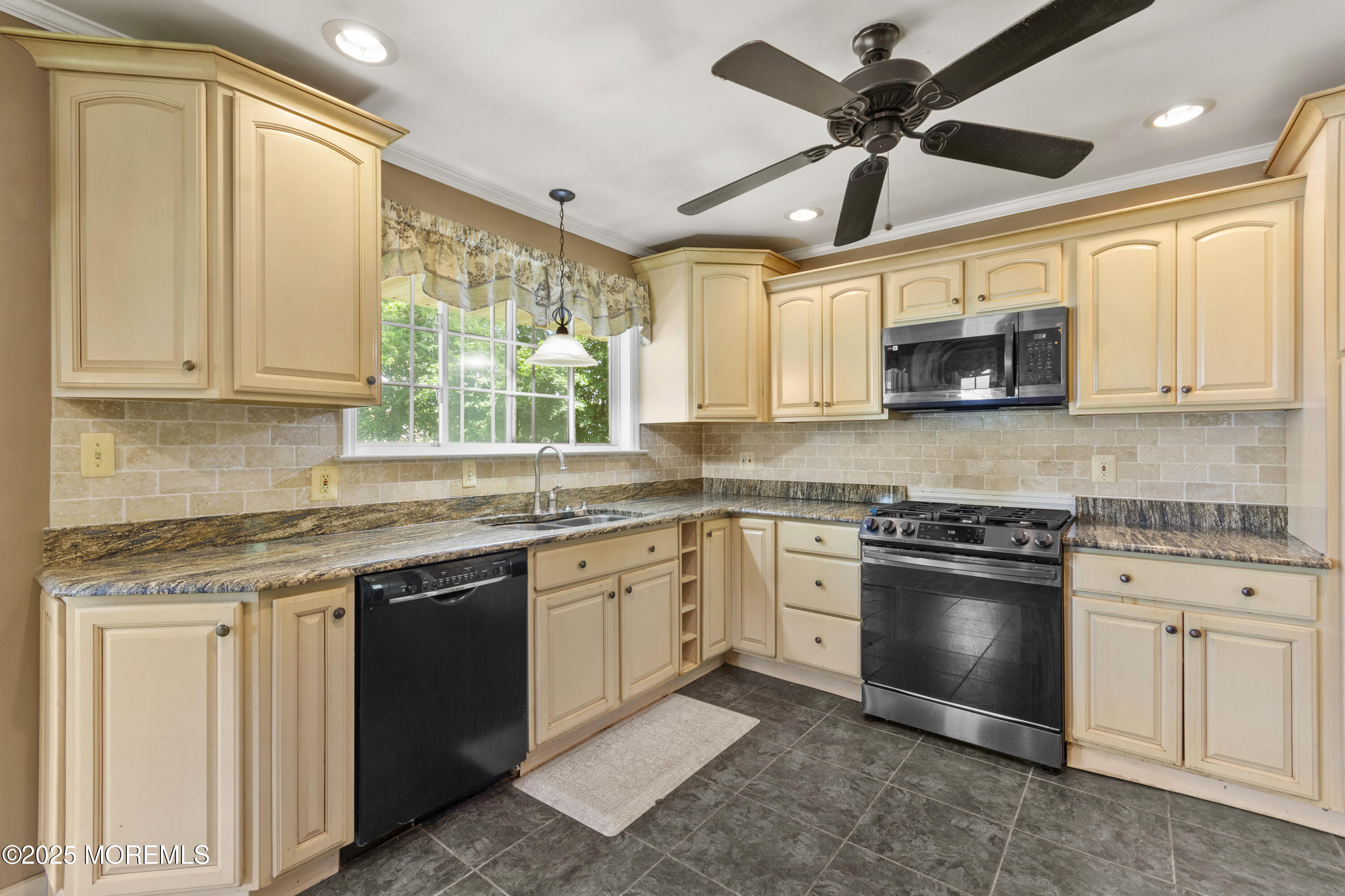 44 Koenig Lane Freehold, NJ 07728 - Photo 10 of 22 a kitchen with stainless steel appliances granite countertop a sink window and cabinets