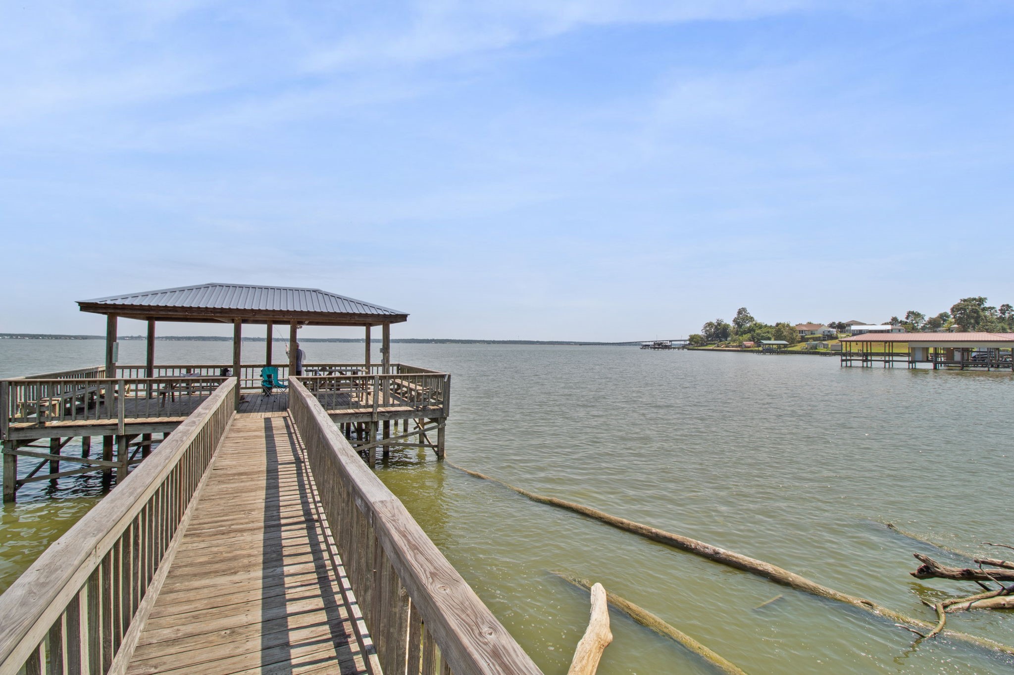 151 Key Largo Loop Point Blank, TX 77364 - Photo 45 of 49 Private fishing pier extends into open water, offering breathtaking lake views and the perfect place to relax, fish, or enjoy spectacular sunsets.