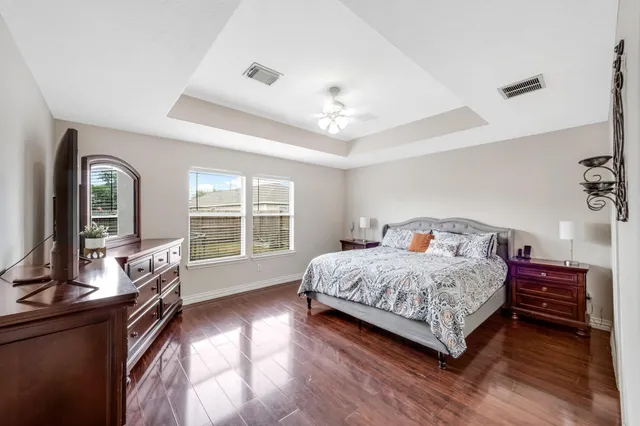 a bedroom with a large bed and a large window