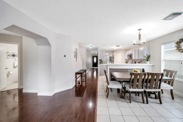a dining room with furniture and wooden floor