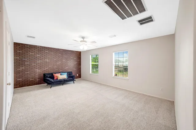 an empty room with furniture and fireplace