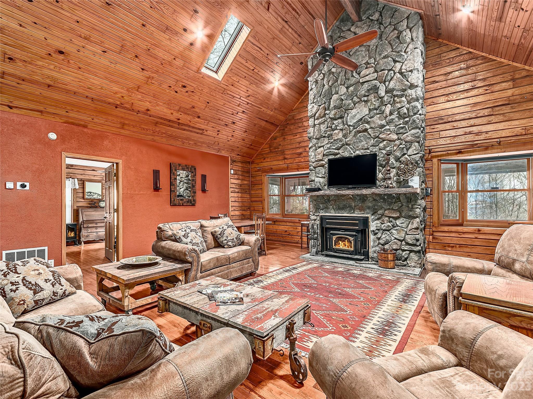 32 Magic Mountain Road Candler, NC 28715 - Photo 1 of 44 a living room with furniture a fireplace and a wooden floor
