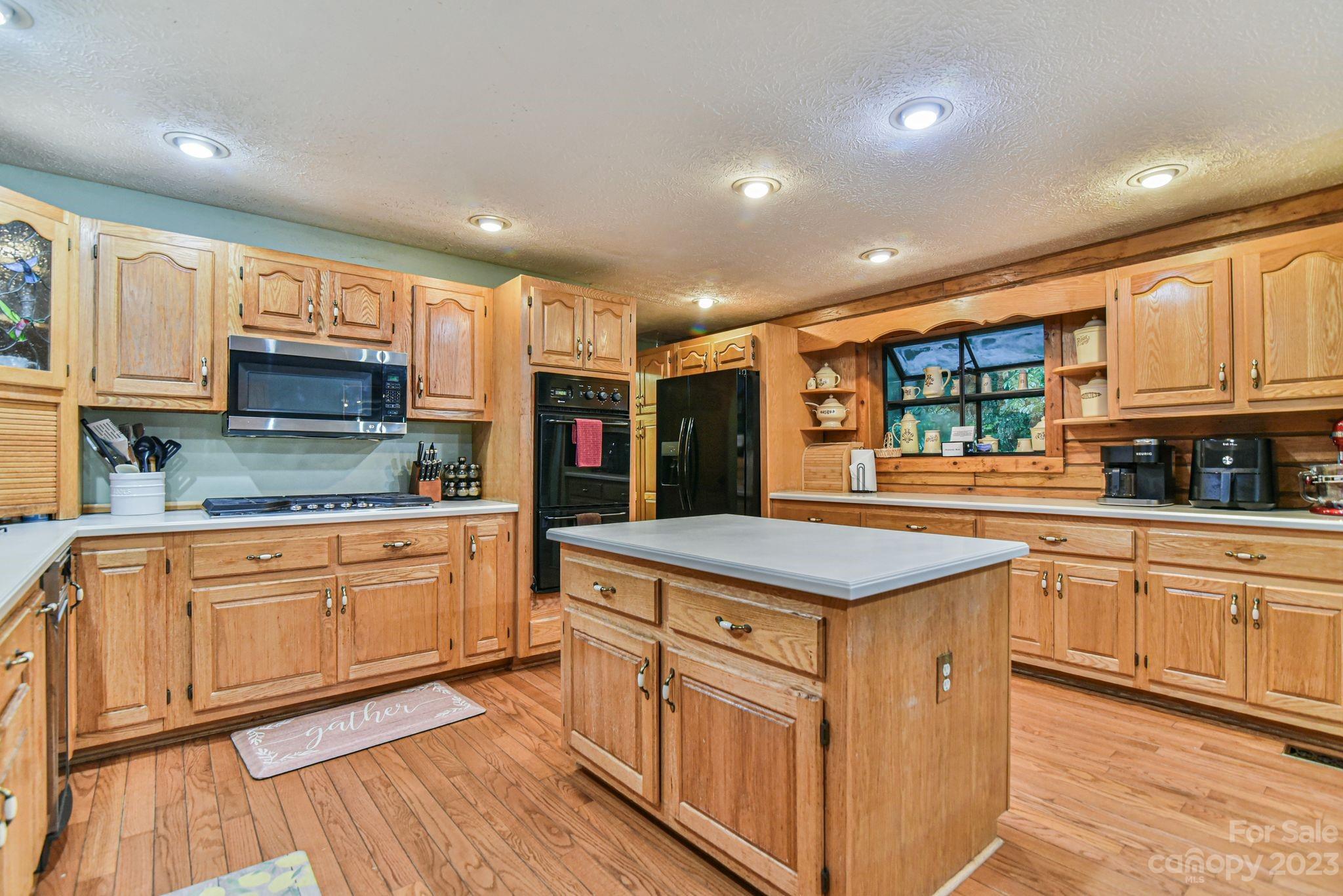 32 Magic Mountain Road Candler, NC 28715 - Photo 13 of 44 a kitchen with stainless steel appliances granite countertop a stove and a sink