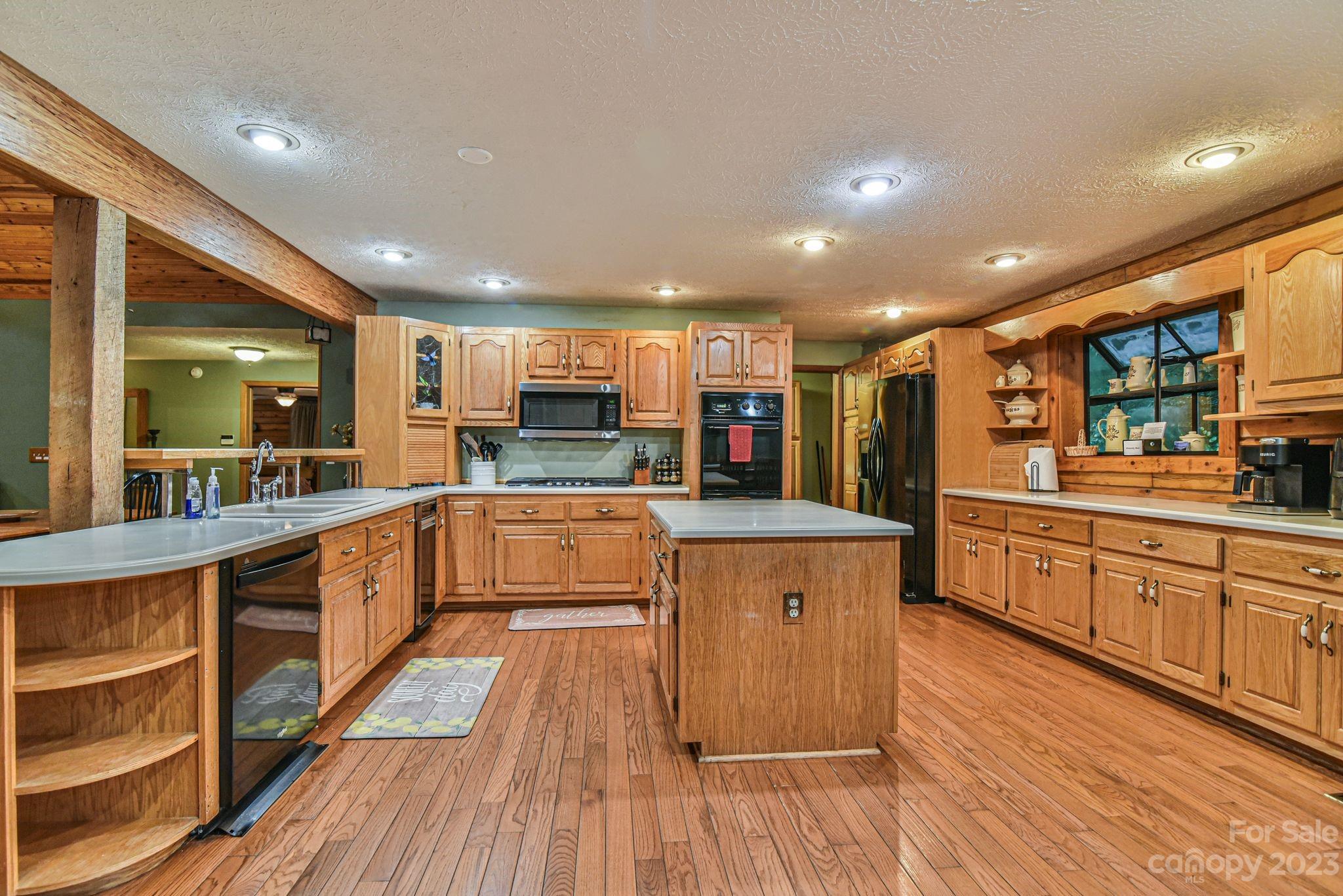 32 Magic Mountain Road Candler, NC 28715 - Photo 14 of 44 a large kitchen with stainless steel appliances and a large counter top