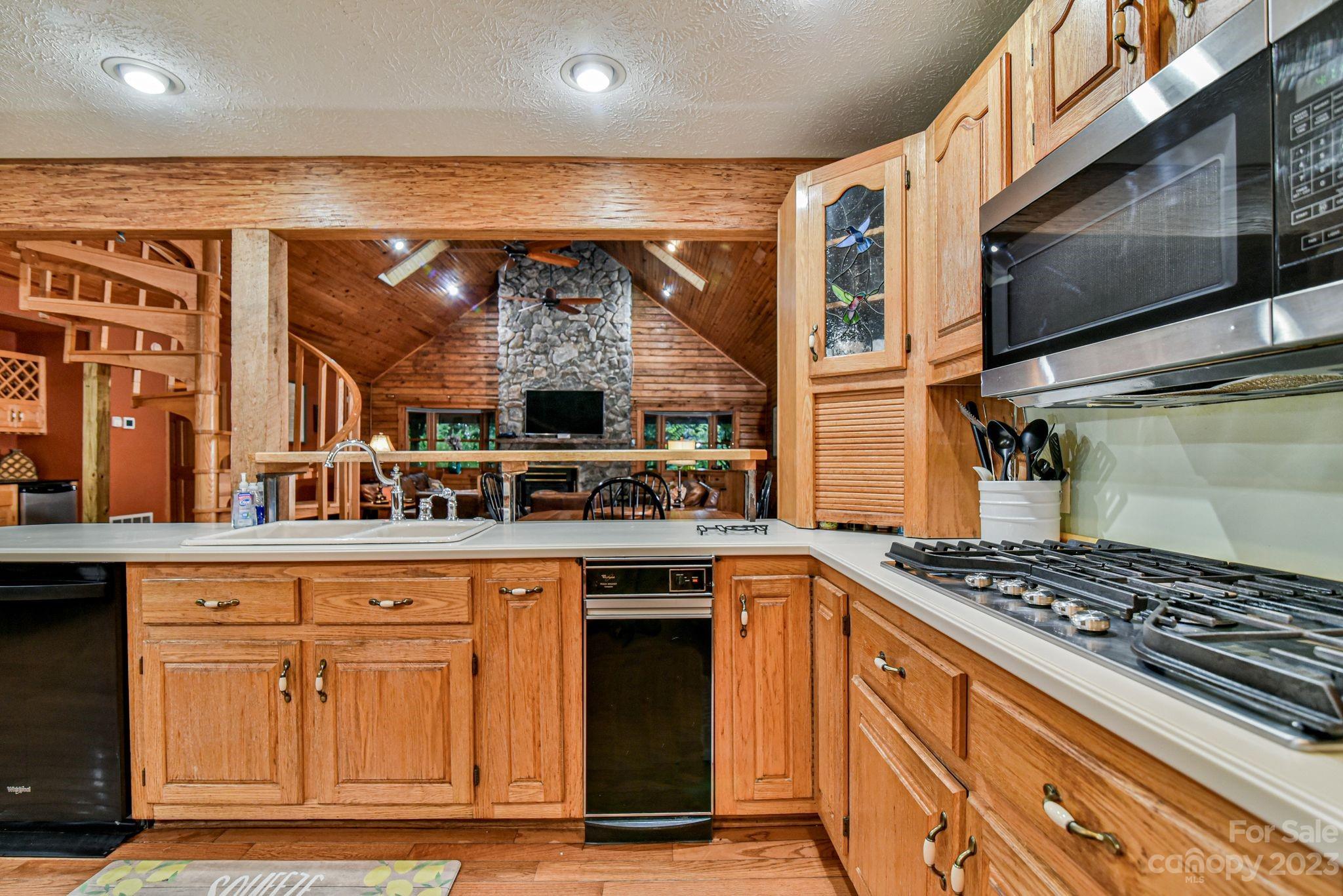 32 Magic Mountain Road Candler, NC 28715 - Photo 16 of 44 a kitchen with stainless steel appliances granite countertop a stove and a microwave