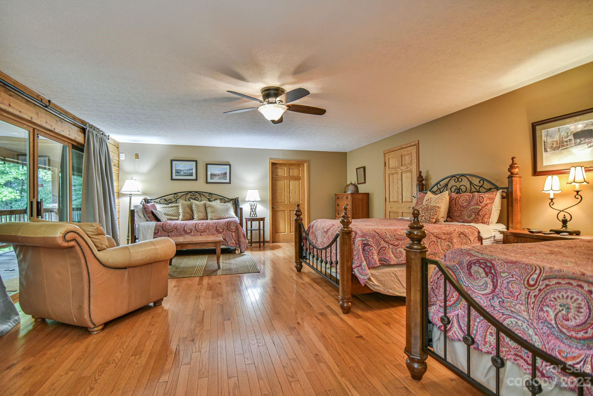 32 Magic Mountain Road Candler, NC 28715 - Photo 18 of 44 a bedroom with furniture and wooden floor