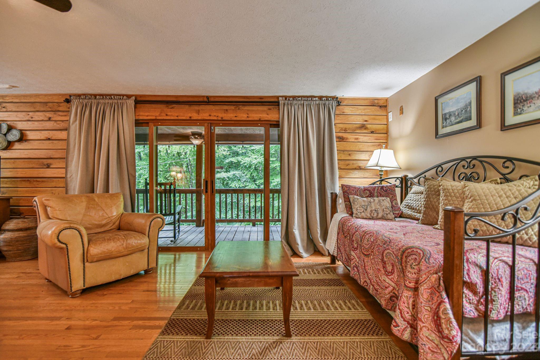 32 Magic Mountain Road Candler, NC 28715 - Photo 19 of 44 a bedroom with furniture and a large window