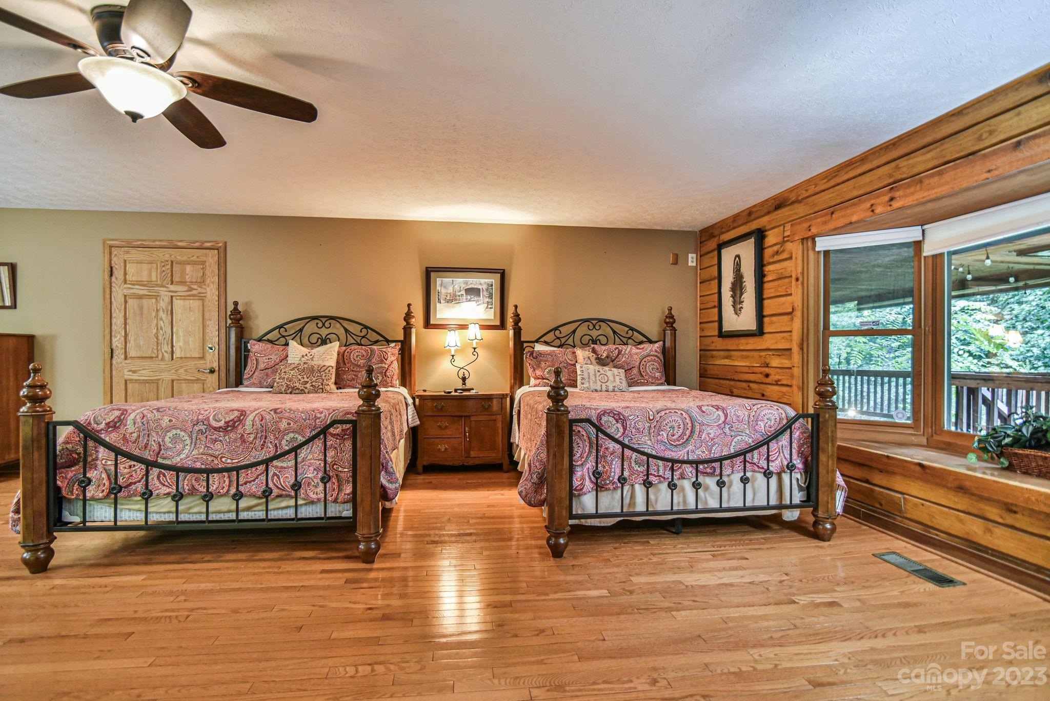 32 Magic Mountain Road Candler, NC 28715 - Photo 20 of 44 a bedroom with a bed mirror and window