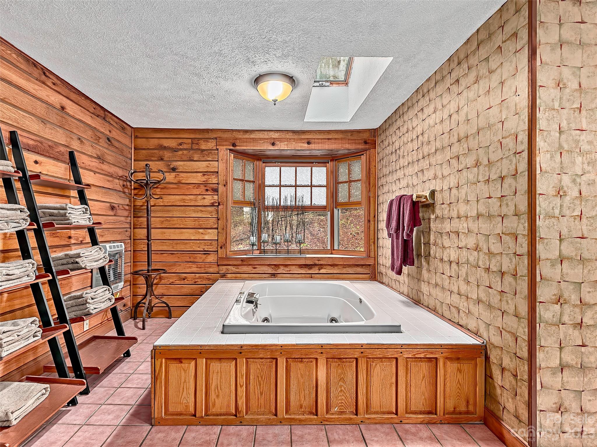 32 Magic Mountain Road Candler, NC 28715 - Photo 22 of 44 a bathroom with a sink and a bathtub