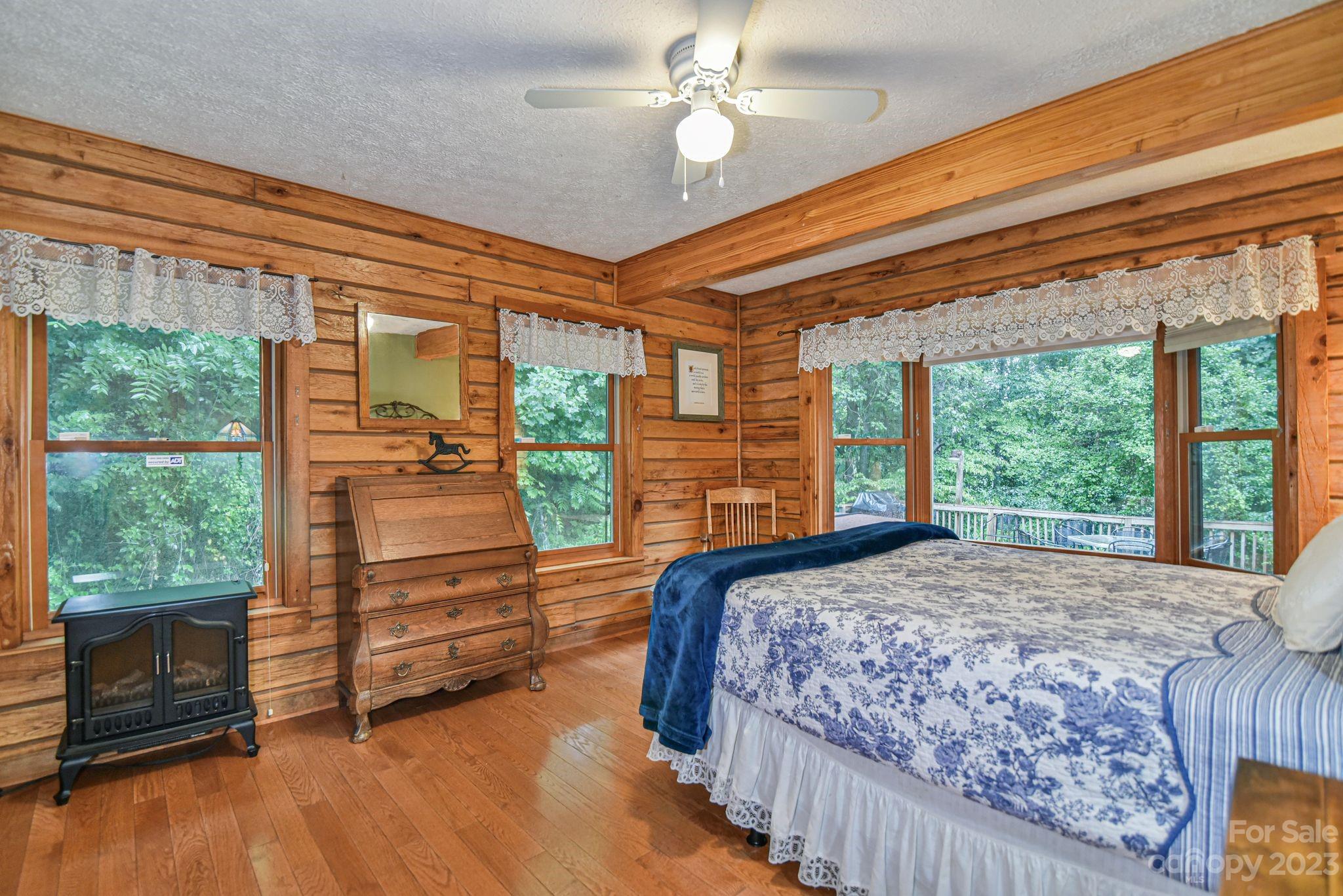 32 Magic Mountain Road Candler, NC 28715 - Photo 23 of 44 a bedroom with a bed and large window