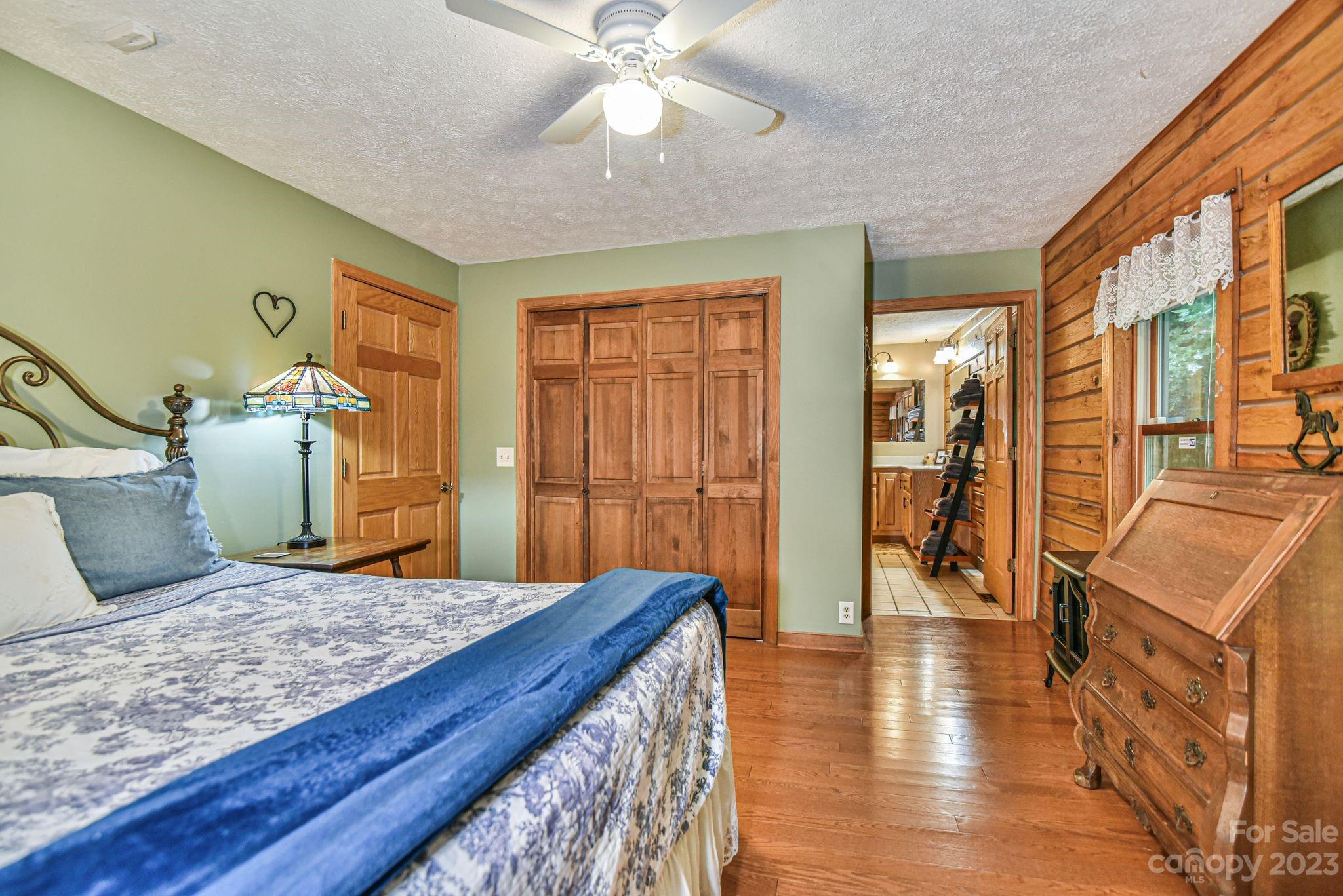 32 Magic Mountain Road Candler, NC 28715 - Photo 24 of 44 a bedroom with a bed and wooden floor