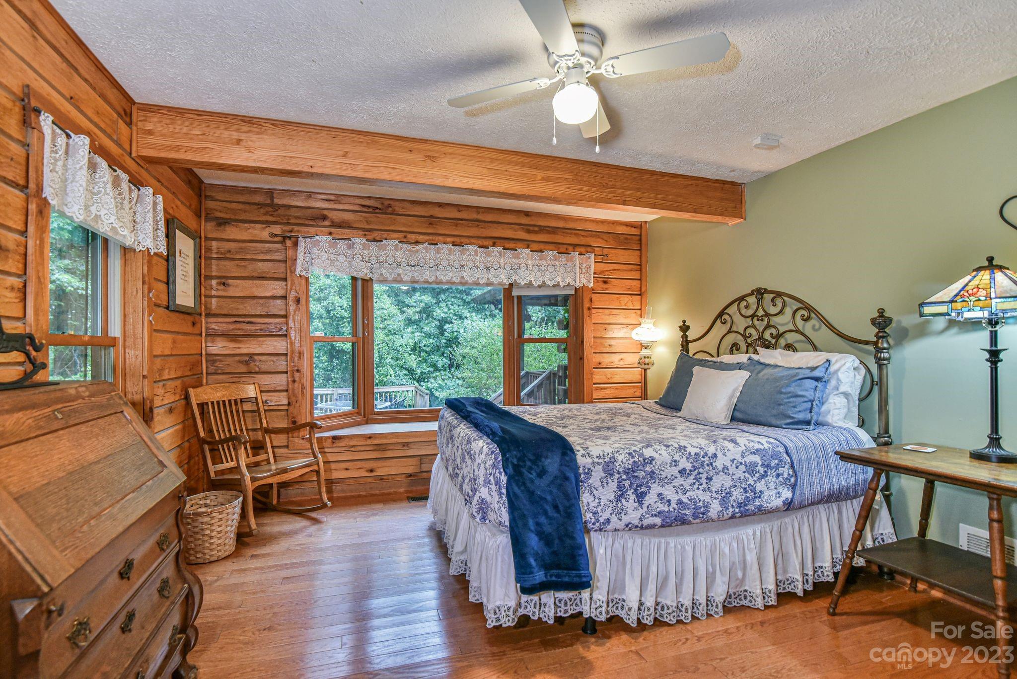 32 Magic Mountain Road Candler, NC 28715 - Photo 25 of 44 a bedroom with a bed and wooden floor