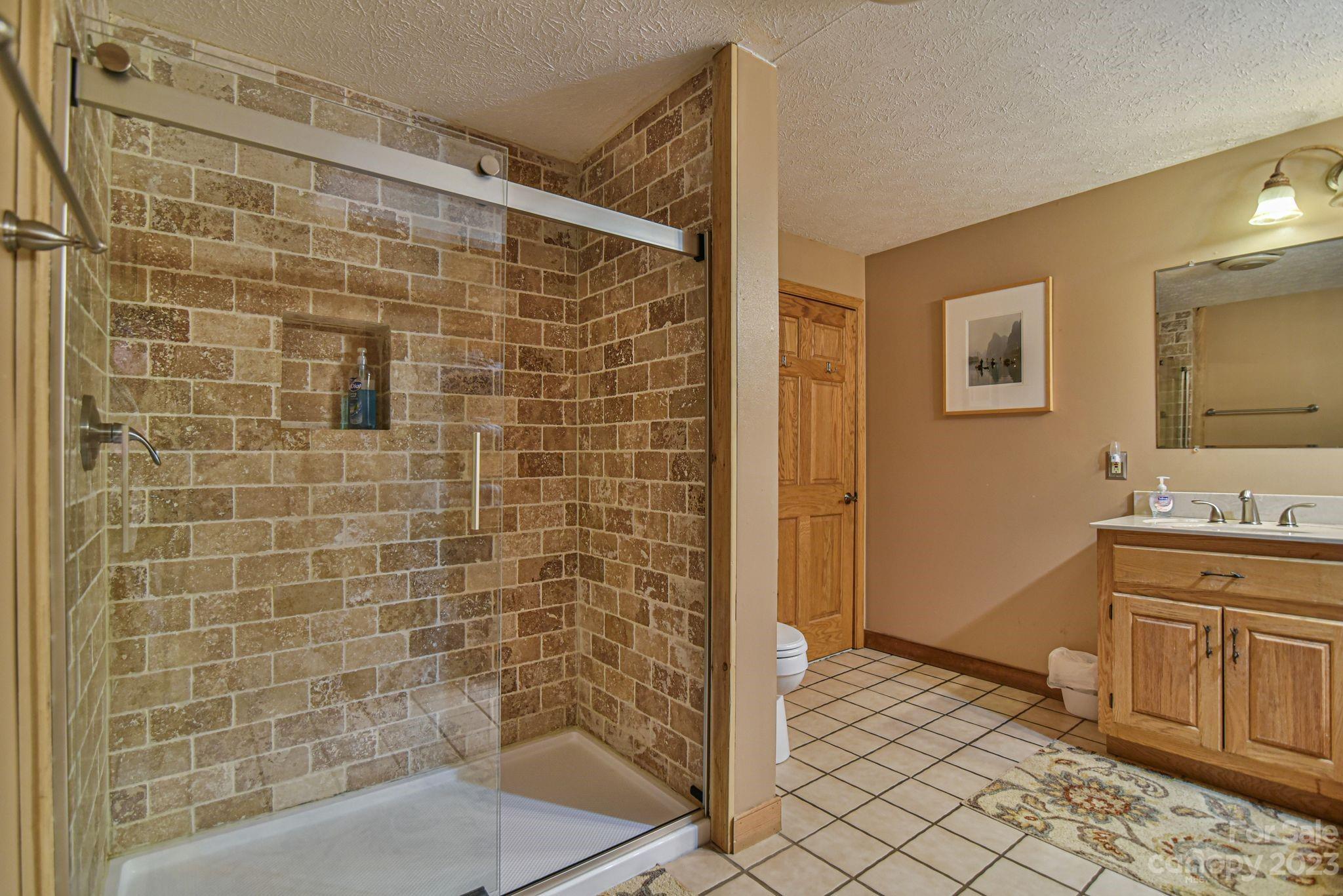 32 Magic Mountain Road Candler, NC 28715 - Photo 27 of 44 a bathroom with a bathtub and shower