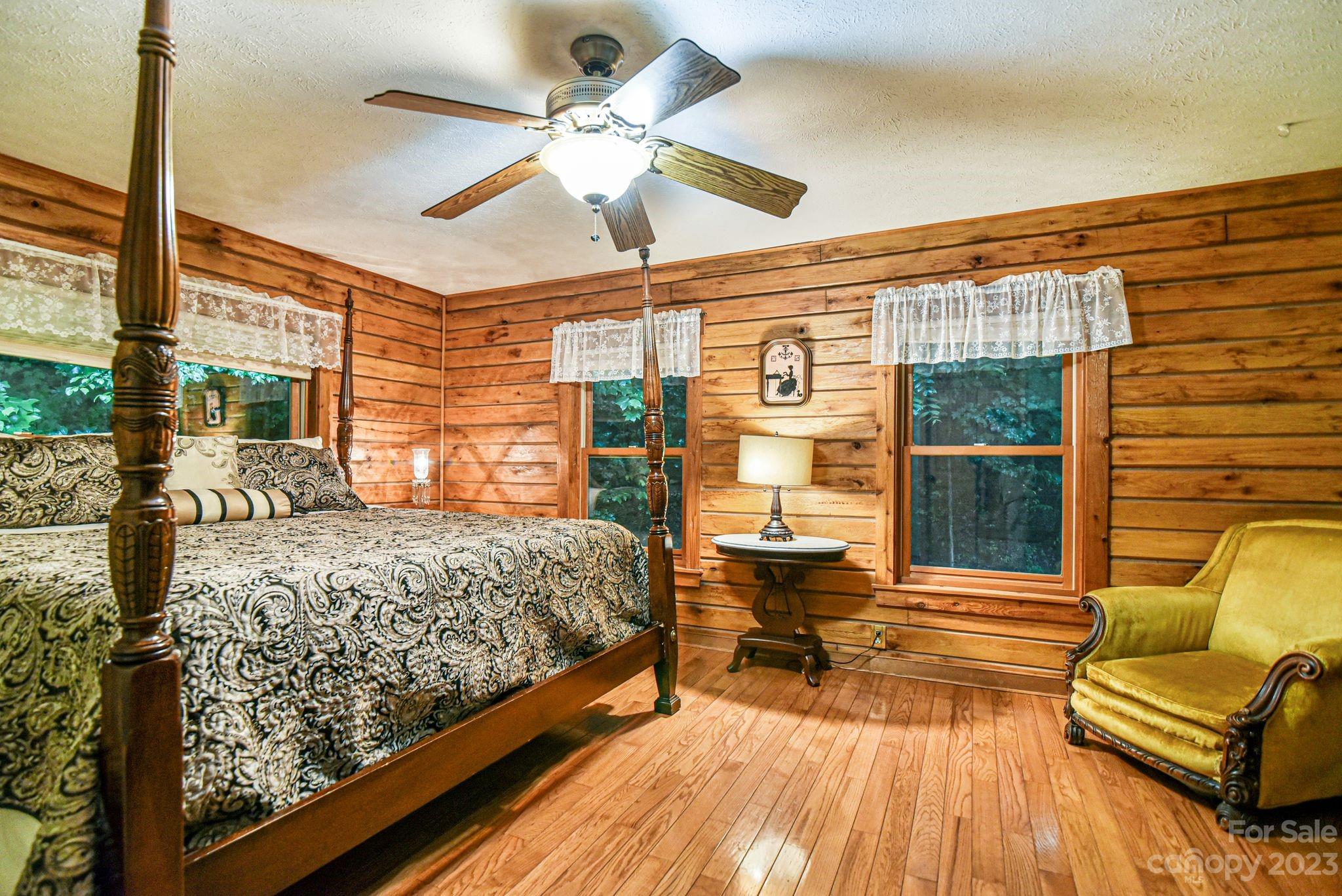 32 Magic Mountain Road Candler, NC 28715 - Photo 29 of 44 a bedroom with a bed and wooden floor