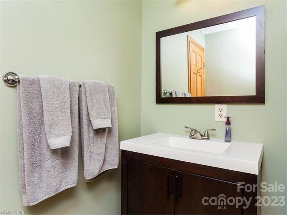 32 Magic Mountain Road Candler, NC 28715 - Photo 34 of 44 a bathroom with a sink and a mirror