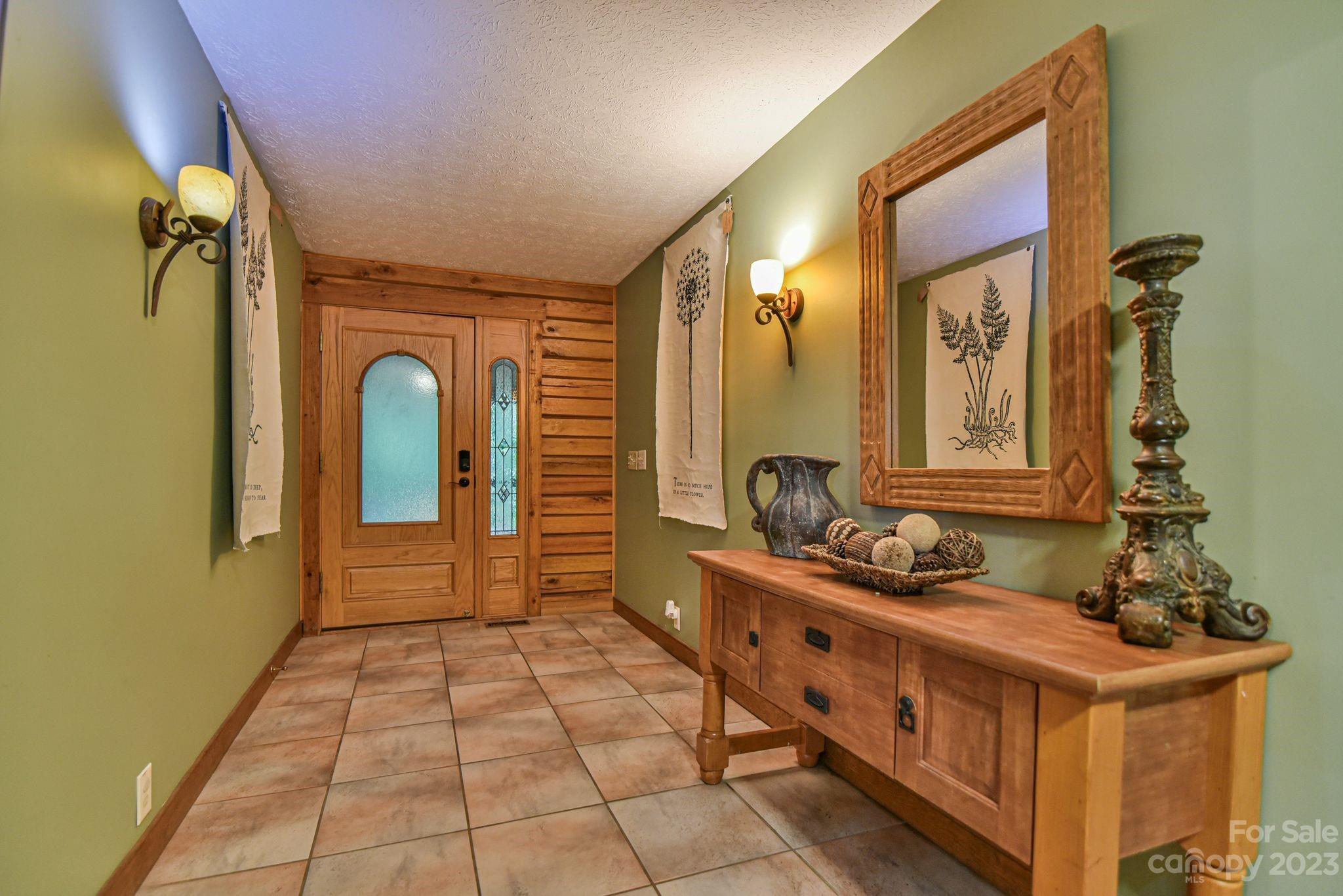 32 Magic Mountain Road Candler, NC 28715 - Photo 7 of 44 a bathroom with a double vanity sink a mirror and a bathtub
