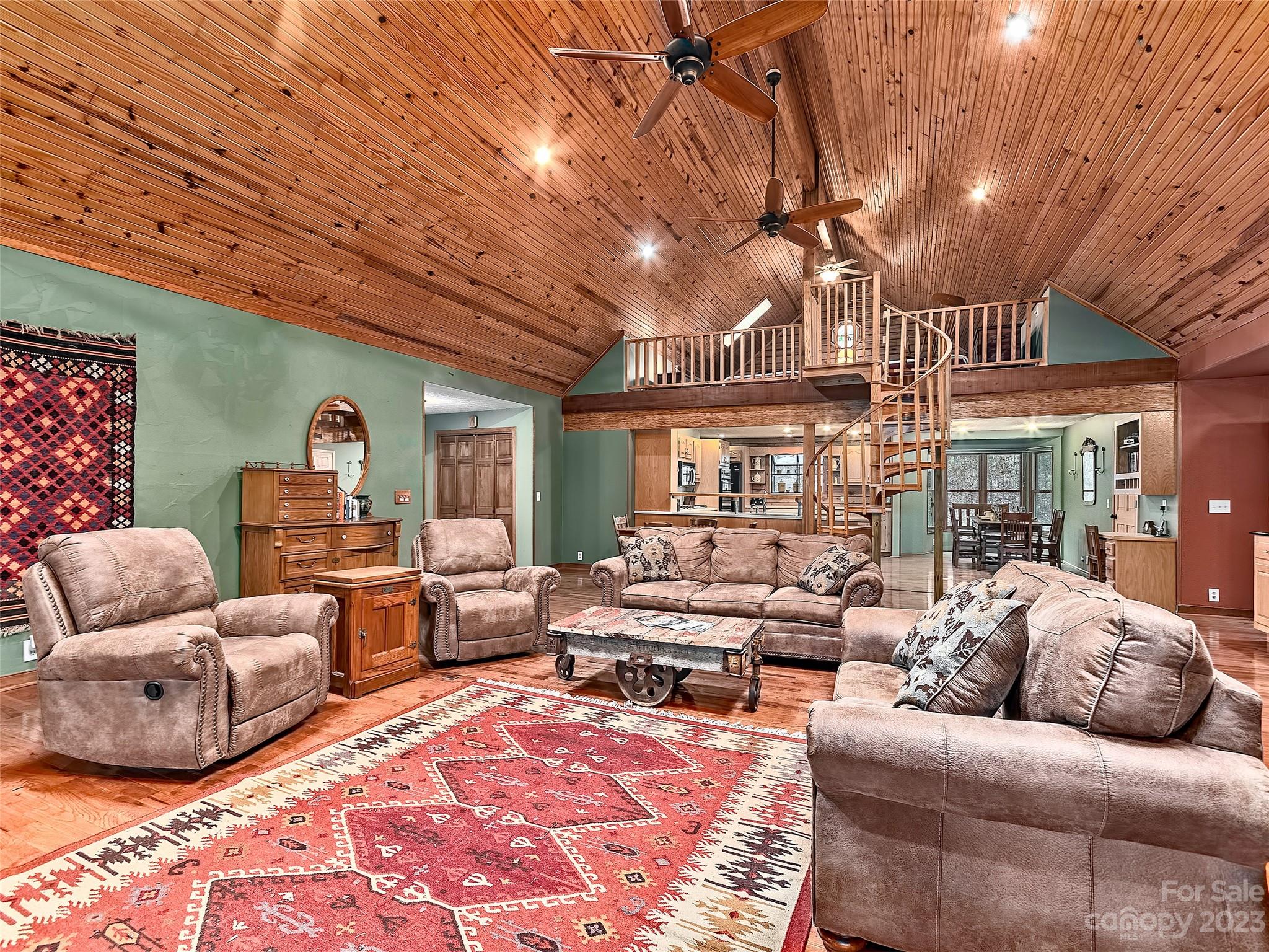 32 Magic Mountain Road Candler, NC 28715 - Photo 9 of 44 a living room with furniture ceiling fan and a rug