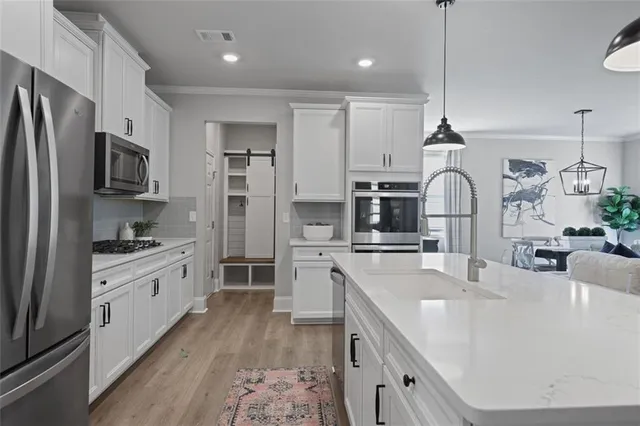 a large kitchen with stainless steel appliances lots of counter space a sink and appliances