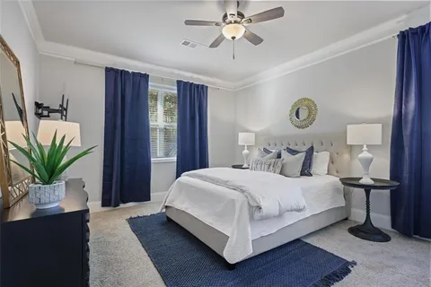 a bedroom with a large bed and a chandelier