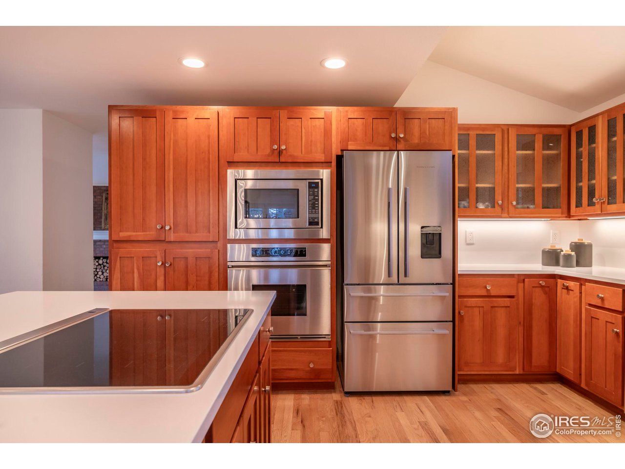 5332 Spotted Horse Trail Boulder, CO 80301 - Photo 11 of 40 a kitchen with stainless steel appliances wooden floor sink and wooden cabinets