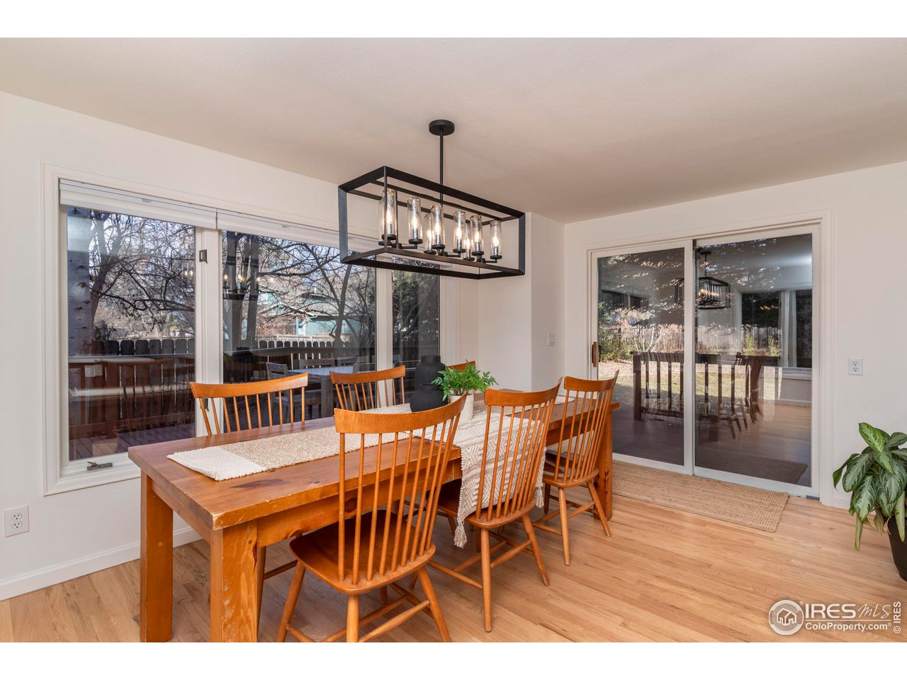 5332 Spotted Horse Trail Boulder, CO 80301 - Photo 15 of 40 a view of a dining room with furniture window and wooden floor