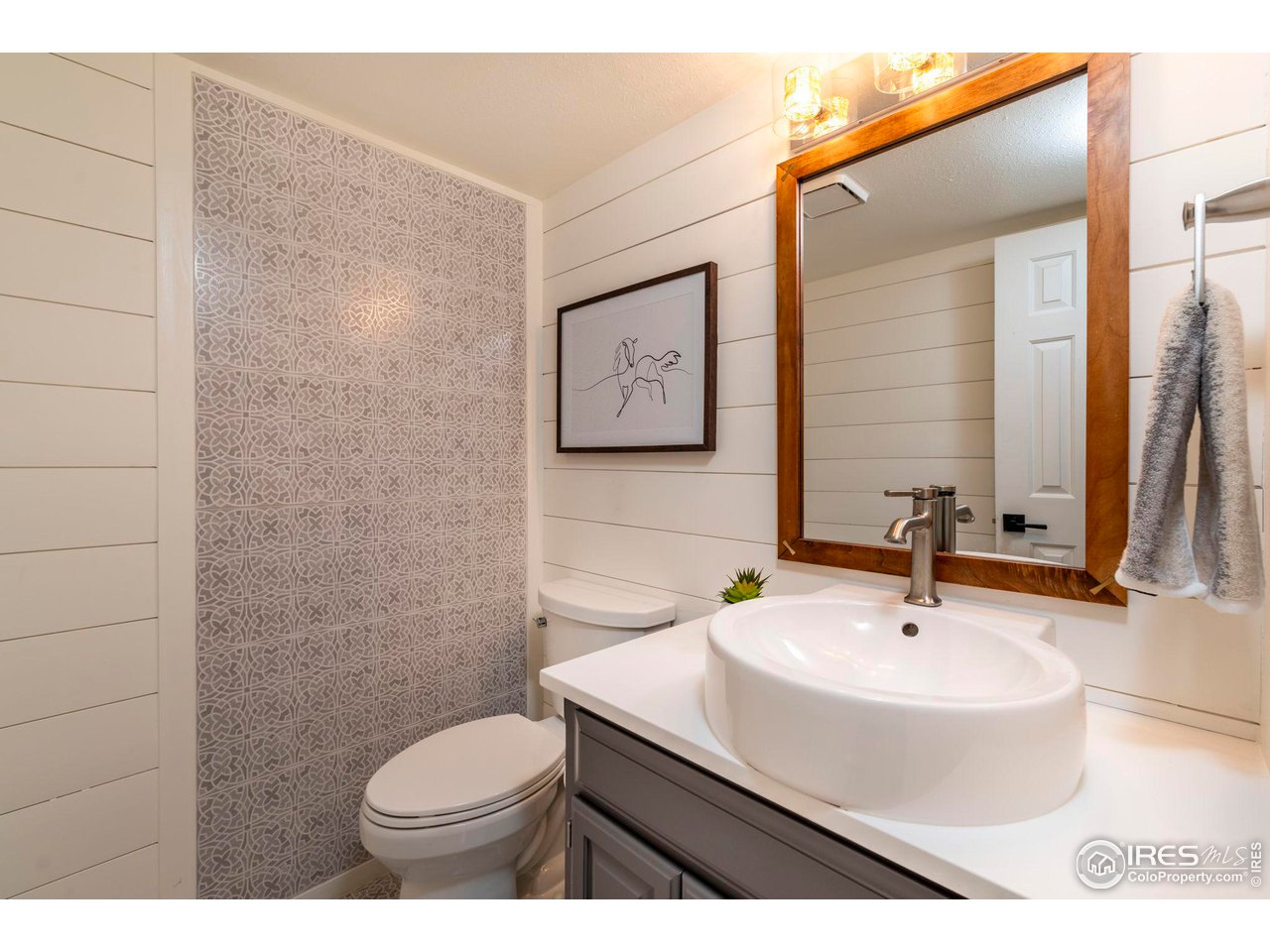 5332 Spotted Horse Trail Boulder, CO 80301 - Photo 19 of 40 a bathroom with a sink a toilet and mirror