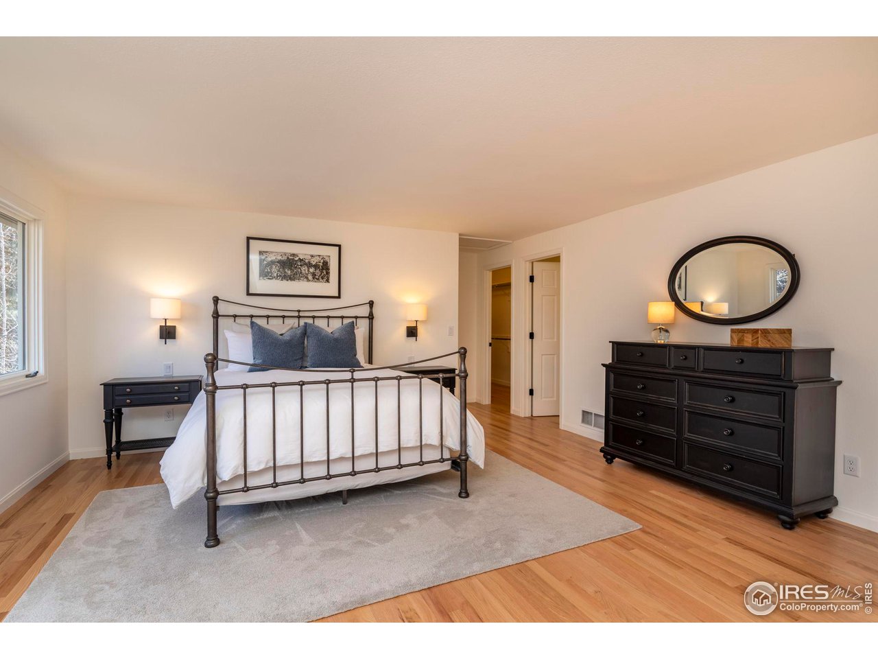 5332 Spotted Horse Trail Boulder, CO 80301 - Photo 22 of 40 a bedroom with a bed and dresser