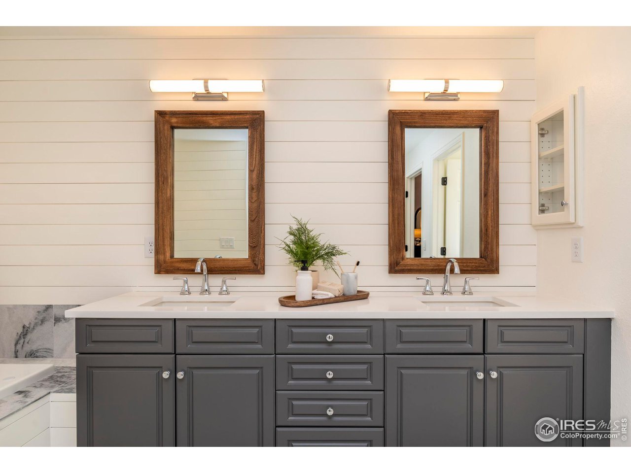 5332 Spotted Horse Trail Boulder, CO 80301 - Photo 26 of 40 a bathroom with a double vanity sink and mirror